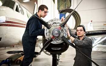 Two aviation students working on an airplane